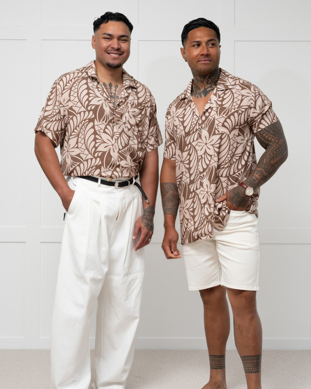 Man wearing a brown floral-patterned island shirt against a white background
