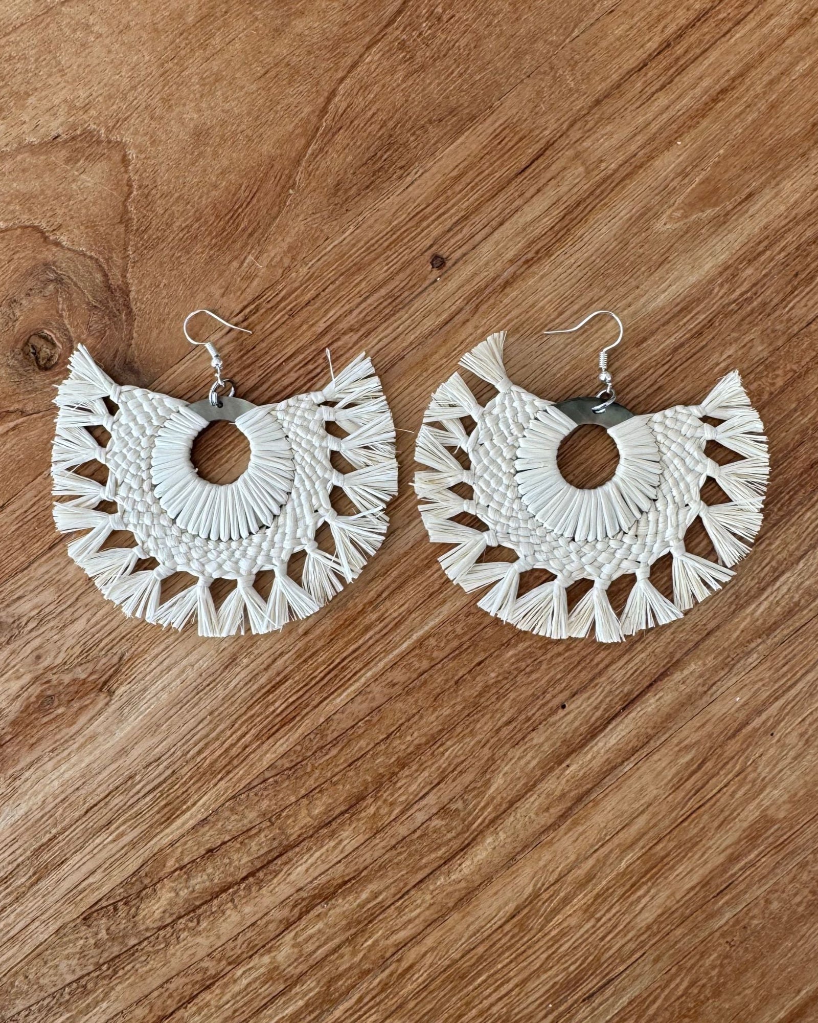 Rito earrings on a wooden surface